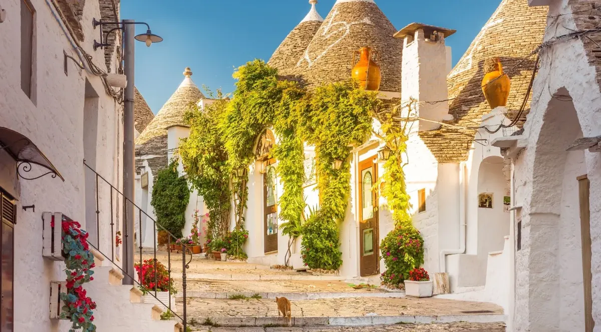Quiet lane framed by whitewashed trulli