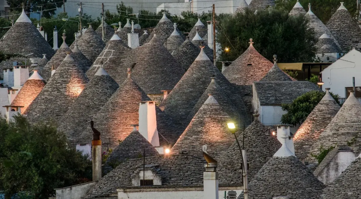 Illuminated trulli roofs at dusk