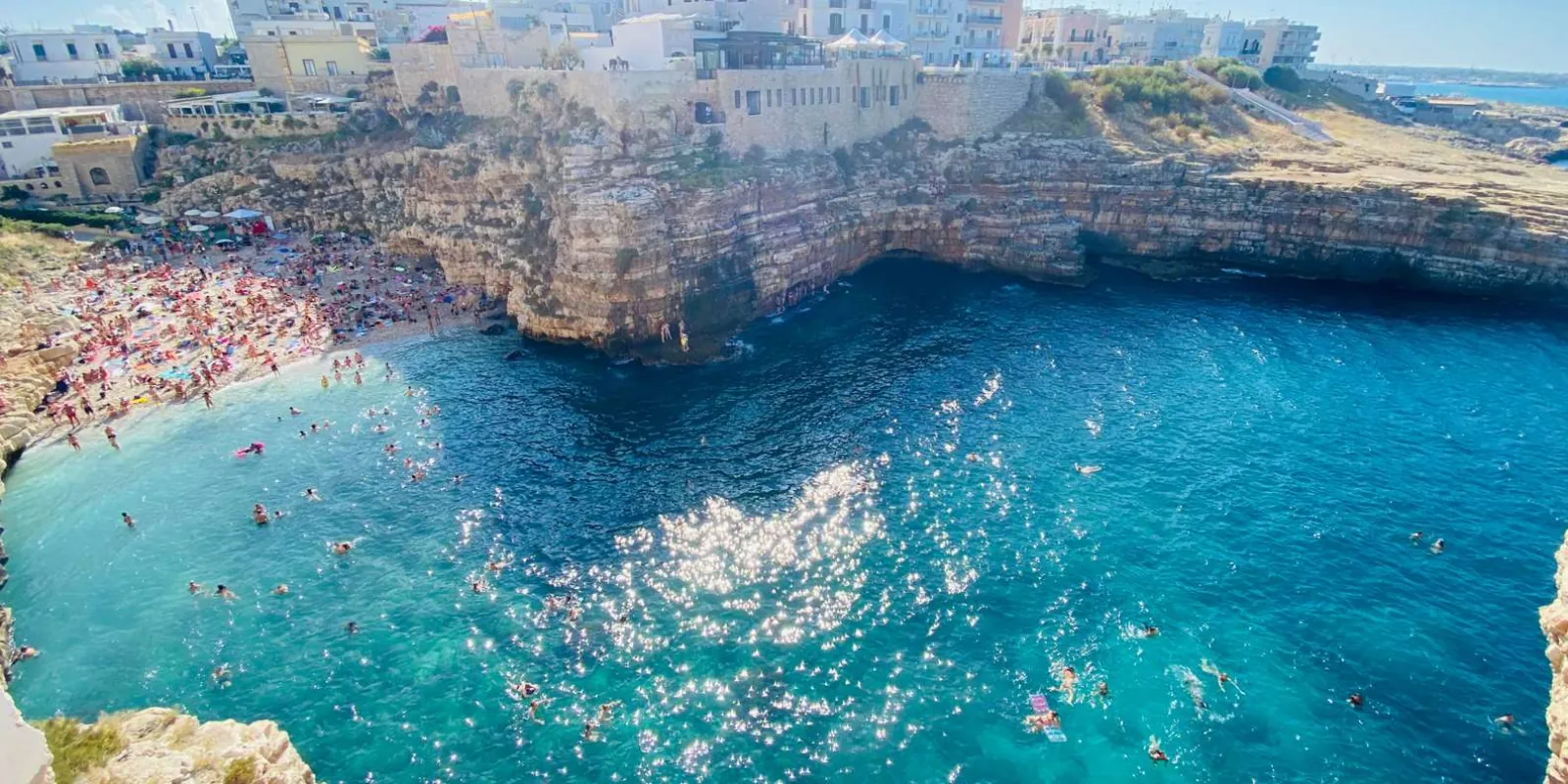 Blue water below Polignano’s coastal cliffs