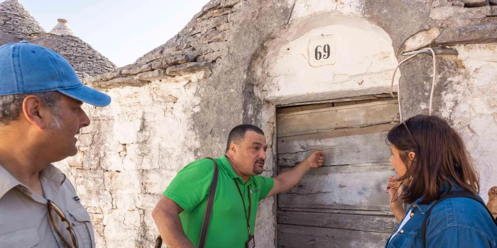 Guide explaining a feature on a stone wall