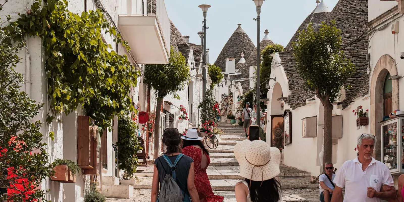 Visitors exploring a narrow trulli street