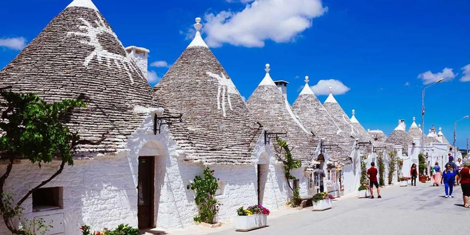 White trulli beneath a blue sky